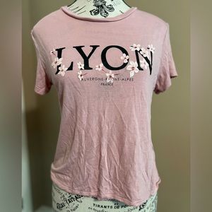 Pink short t-shirt with the word LYON on it.